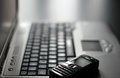 modern laptop keyboard beside vintage phone, showcasing the evolution of technology and communication tools.
