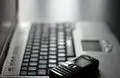 modern laptop keyboard beside vintage phone, showcasing the evolution of technology and communication tools.