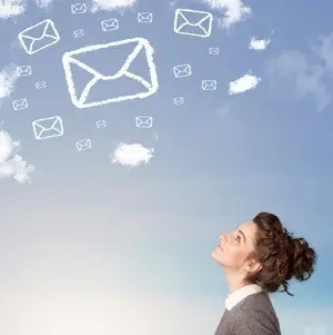 Microsoft Exchange Online Review: What Microsoft Exchange Online Can Offer You 3 young woman gazing at sky, reflecting on messages symbolized by floating envelopes and clouds.
