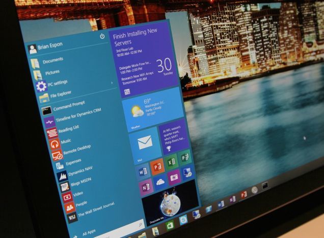 windows interface with start menu, weather widget, and cityscape background at night.
