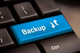 bright blue backup key on a sleek keyboard emphasizes the importance of data protection.