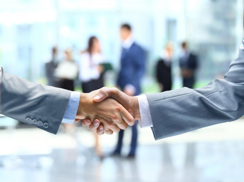 confident handshake signifies collaboration and success in a professional business environment.
