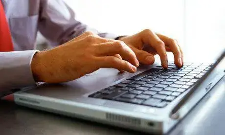 Computer Tip Of The Week - Let Autocorrects Make You A Much Faster Typist 1 person typing efficiently on a laptop, showcasing professionalism with autocorrect tools in action.