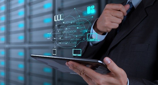 professional in a suit uses a tablet in a high-tech server room for it support tasks.