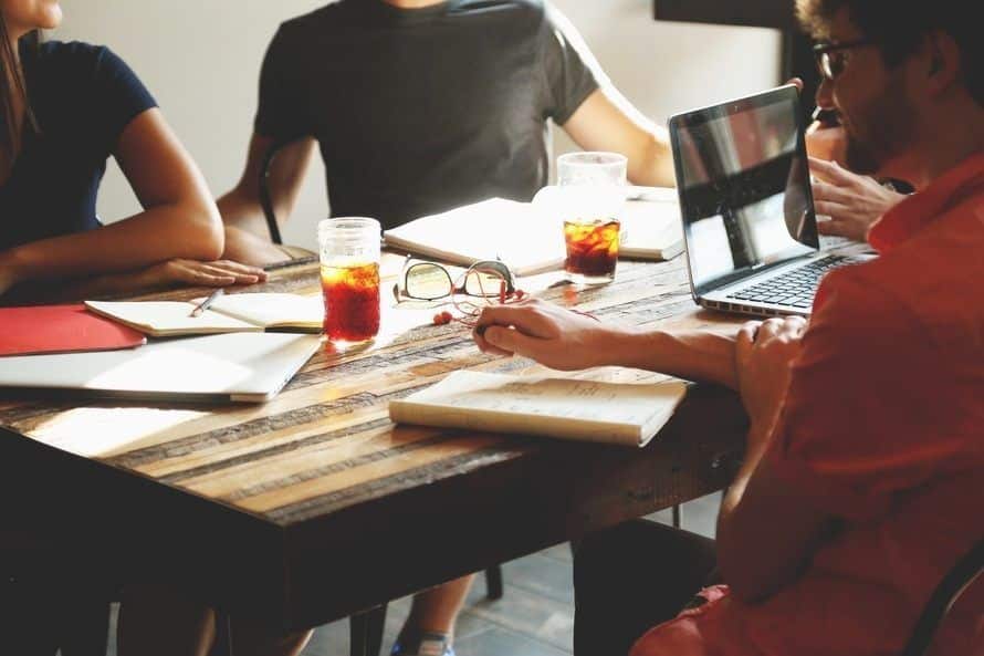 collaborative brainstorming session for long island businesses around a rustic table with refreshments.