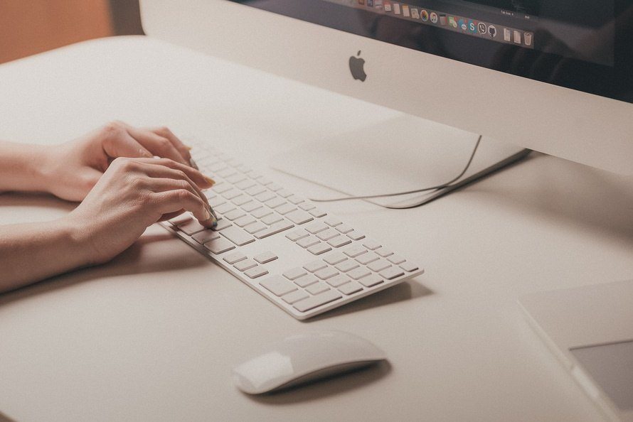 sleek apple workspace features a minimalist keyboard and monitor for enhanced productivity.