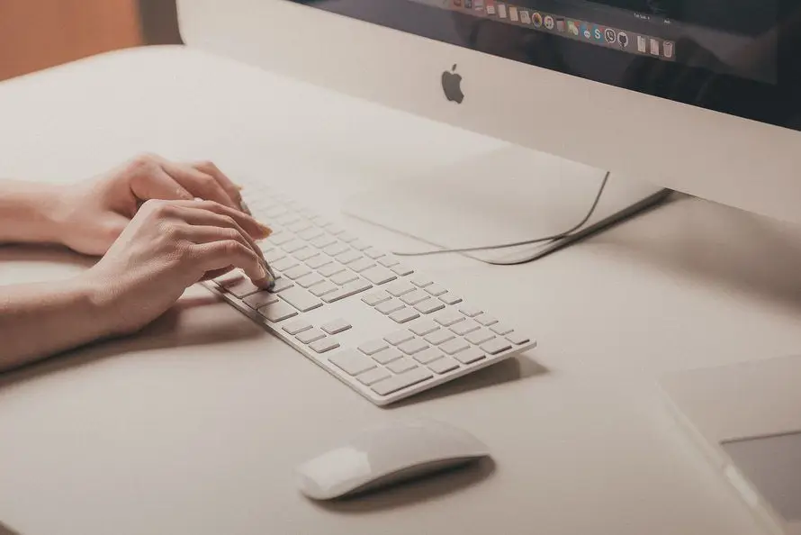 Increase Productivity With These 3 Basic Keyboard Shortcuts 1 sleek apple workspace features a minimalist keyboard and monitor for enhanced productivity.