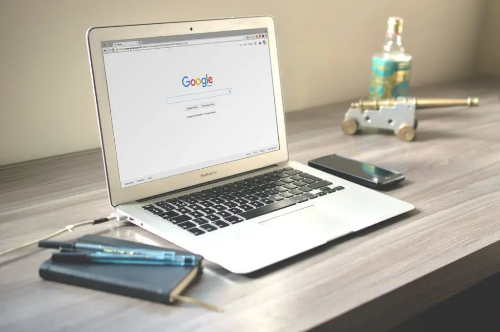 Make Safer Decisions Involving The Internet Of Things 5 minimalist workspace with macbook air, notebook, smartphone, and decorative elements for creativity.