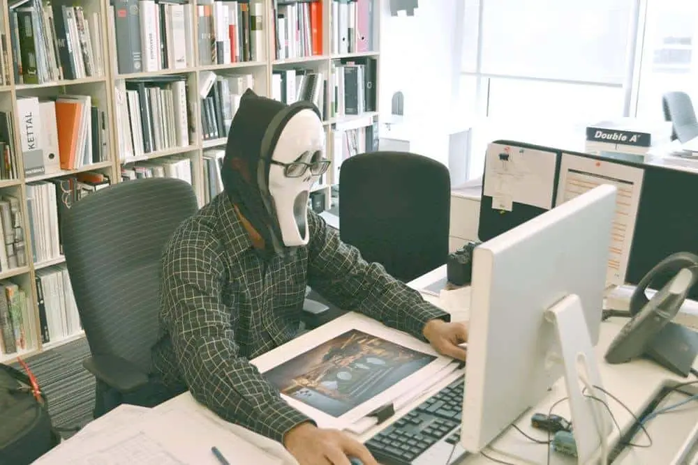 What Is The Best Way To Protect Your Business From Hackers 1 casual office worker in a horror mask, merging creativity and humor in a professional setting.
