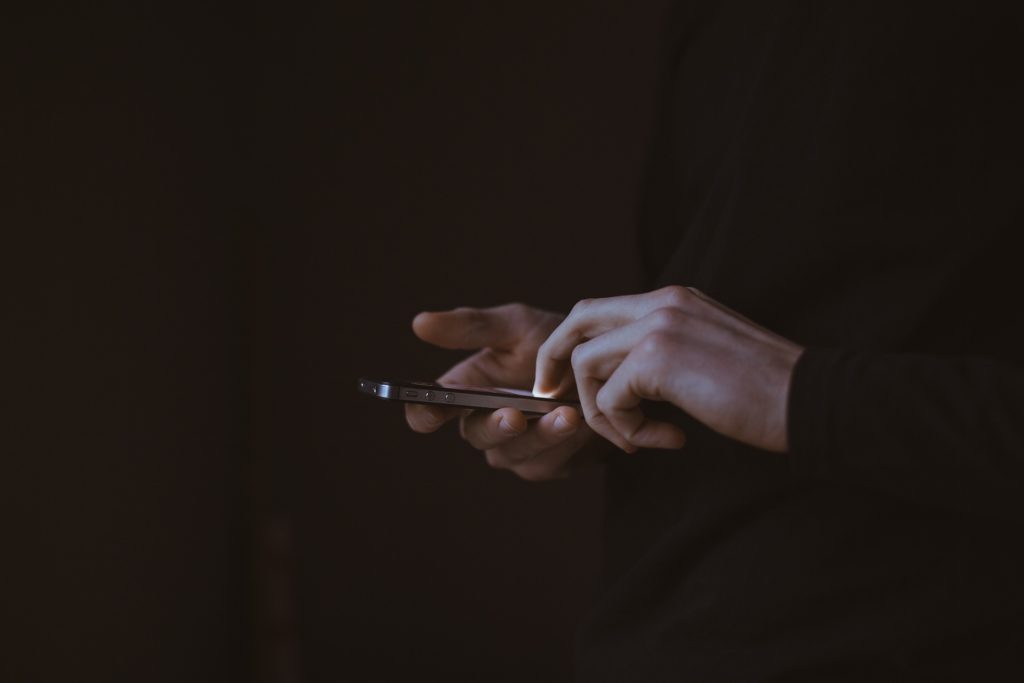 hands holding a smartphone, showcasing focus and connection in modern digital communication.