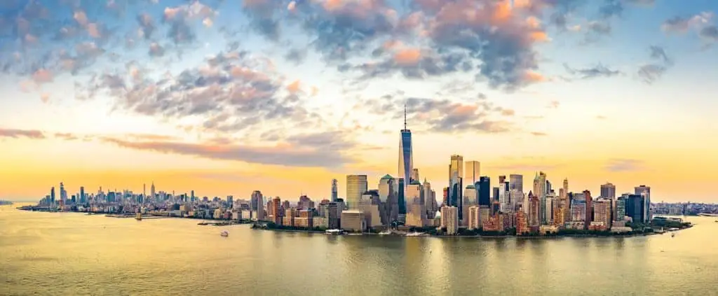 Stunning city skyline at dusk with vibrant reflections in calm waters.
