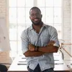 confident business owner in a stylish office, smiling and embodying professionalism and approachability.