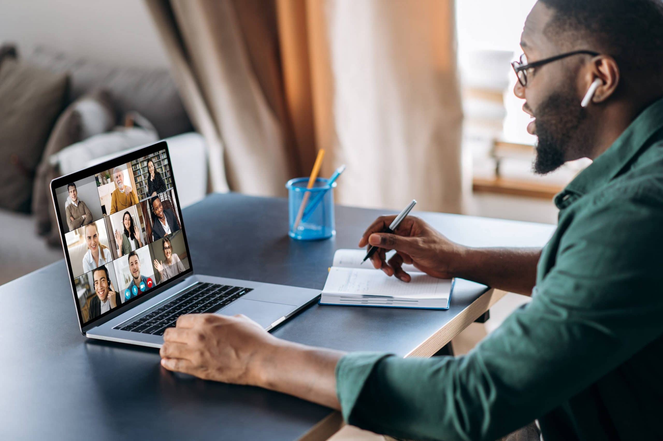Online business briefing. Male African American employee speak on video call with diverse multiracial colleagues, on laptop screen diverse business people, meeting online, group brainstorm, remote work