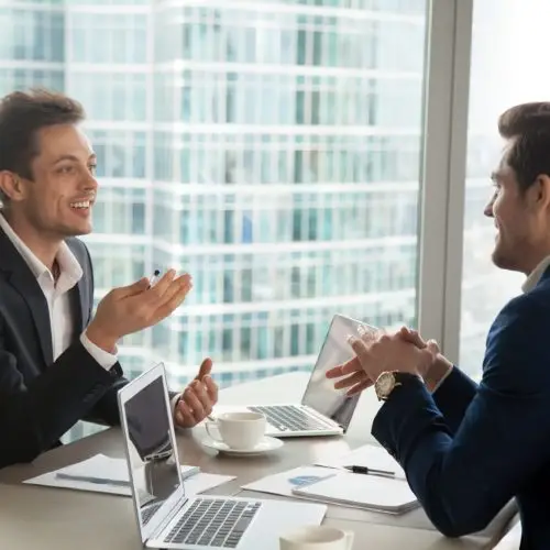 young professionals discussing ideas in a modern office with a stunning city skyline view.