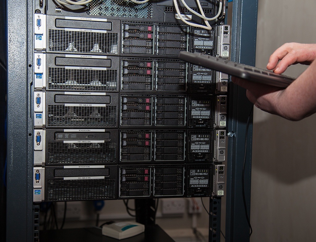 it professional troubleshooting server rack with laptop in a modern data center.