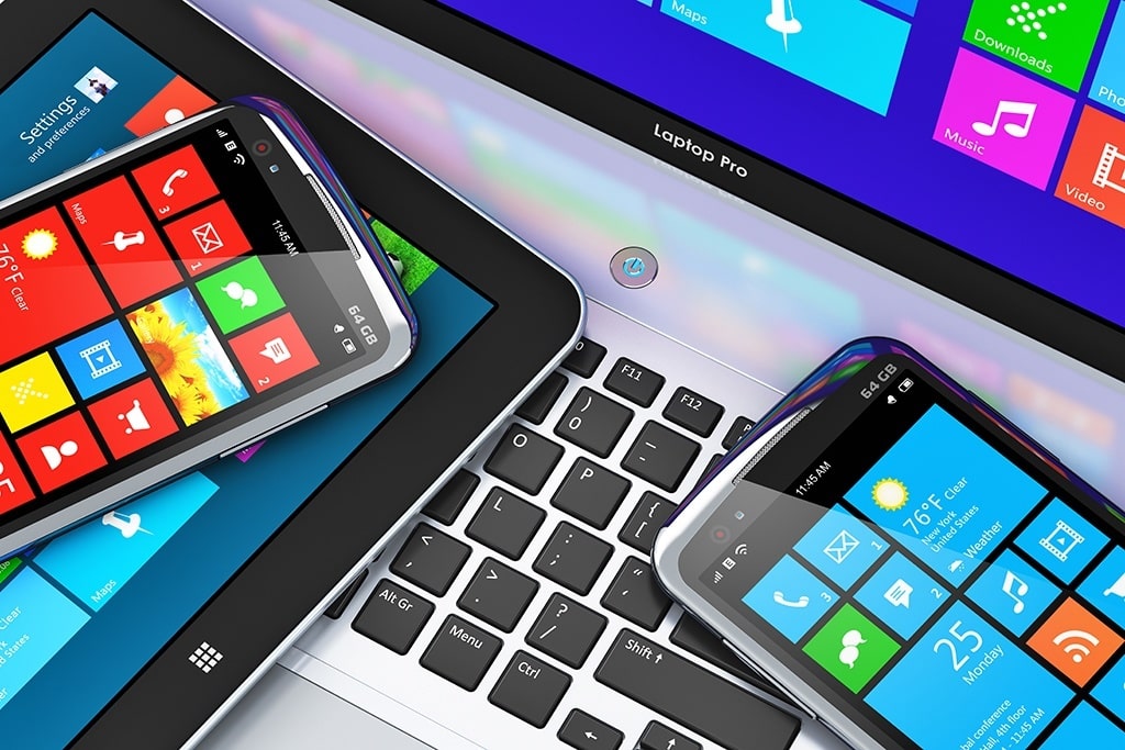 smartphones and laptop displaying vibrant windows interfaces, showcasing modern tech integration and connectivity.