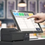 hand working point of sale system at a store