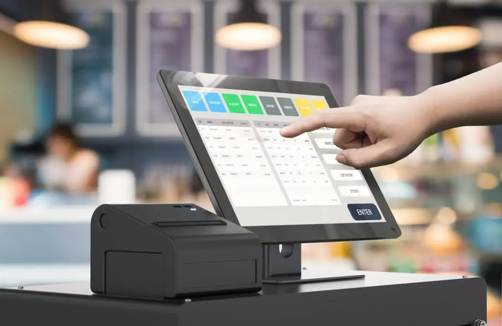 How Get The Most Out Of Your Pos System 1 user engages with a modern pos touchscreen tablet in a bustling café setting.