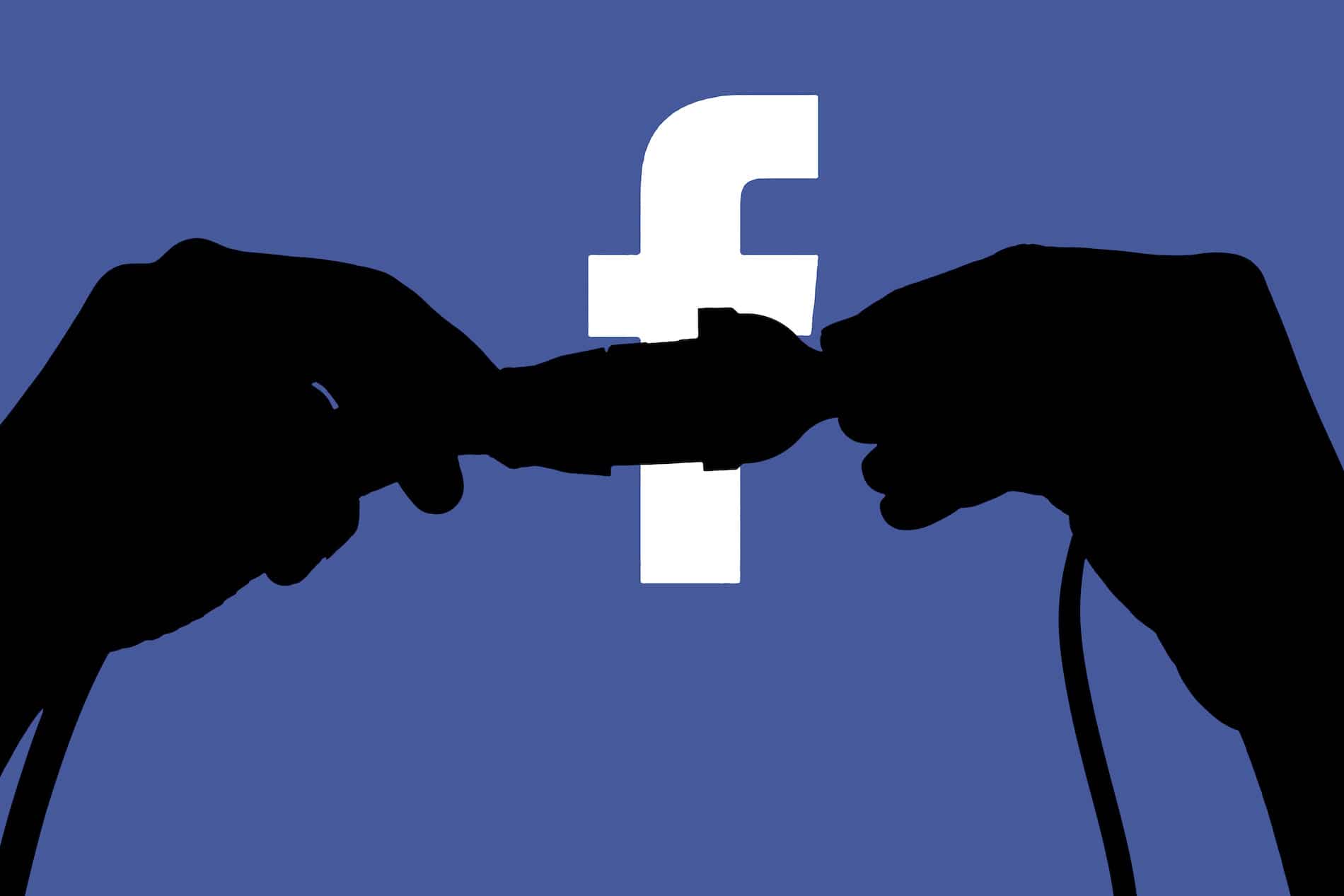 silhouetted hands pulling apart a cord against the facebook logo, symbolizing disconnection from social media.
