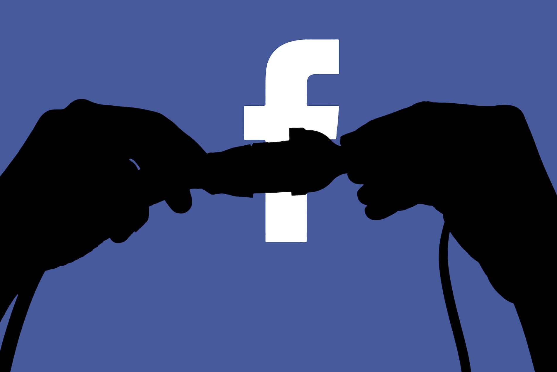 Switching off Facebook. Silhouette of person hands disconnecting plugs, symbol of Facebook global outage