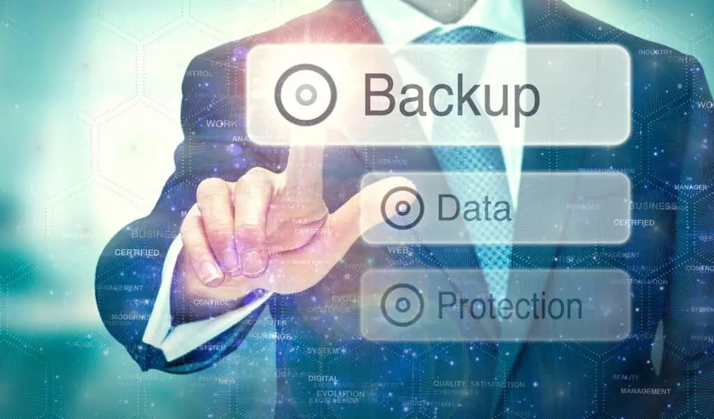 businessman in a suit interacts with a digital backup button in a high-tech environment.