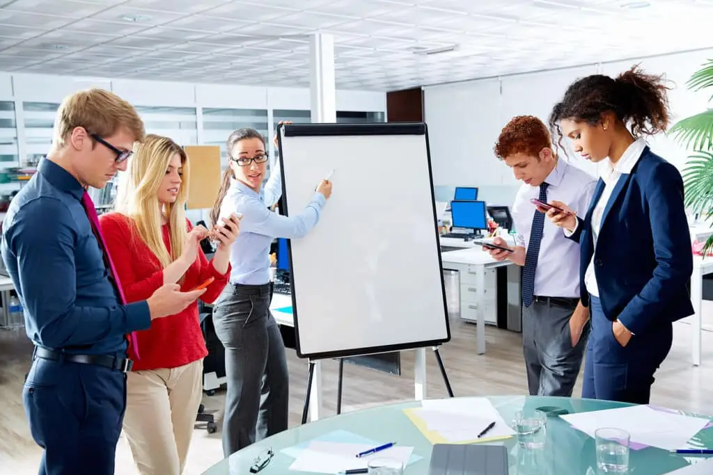 Tip Of The Week: Ways To Improve Focus 3 young professionals brainstorming in a bright, modern office during a collaborative meeting session.