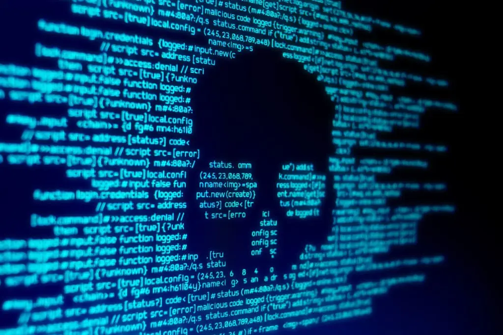 What Might Cyberattacks Look Like In The Future? 1 skull icon amidst code symbolizes digital security threats and the risks of cybercrime.