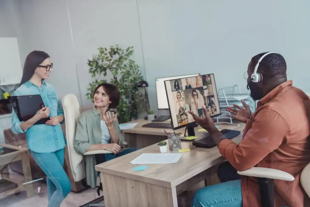 dynamic office meeting with recruiter interviewing applicants, showcasing teamwork and modern hybrid work culture.