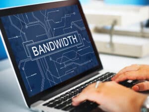 a person typing on a laptop with the word bandwhit on it