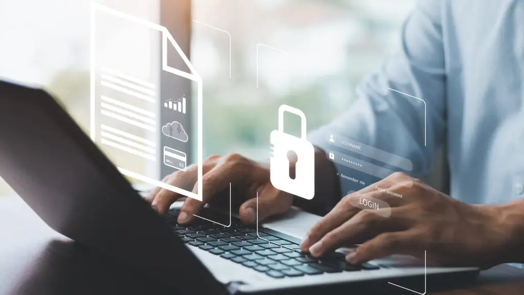 Person typing on laptop with data security icons in a bright, modern workspace.
